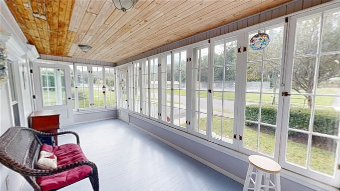The glass-enclosed front porch
