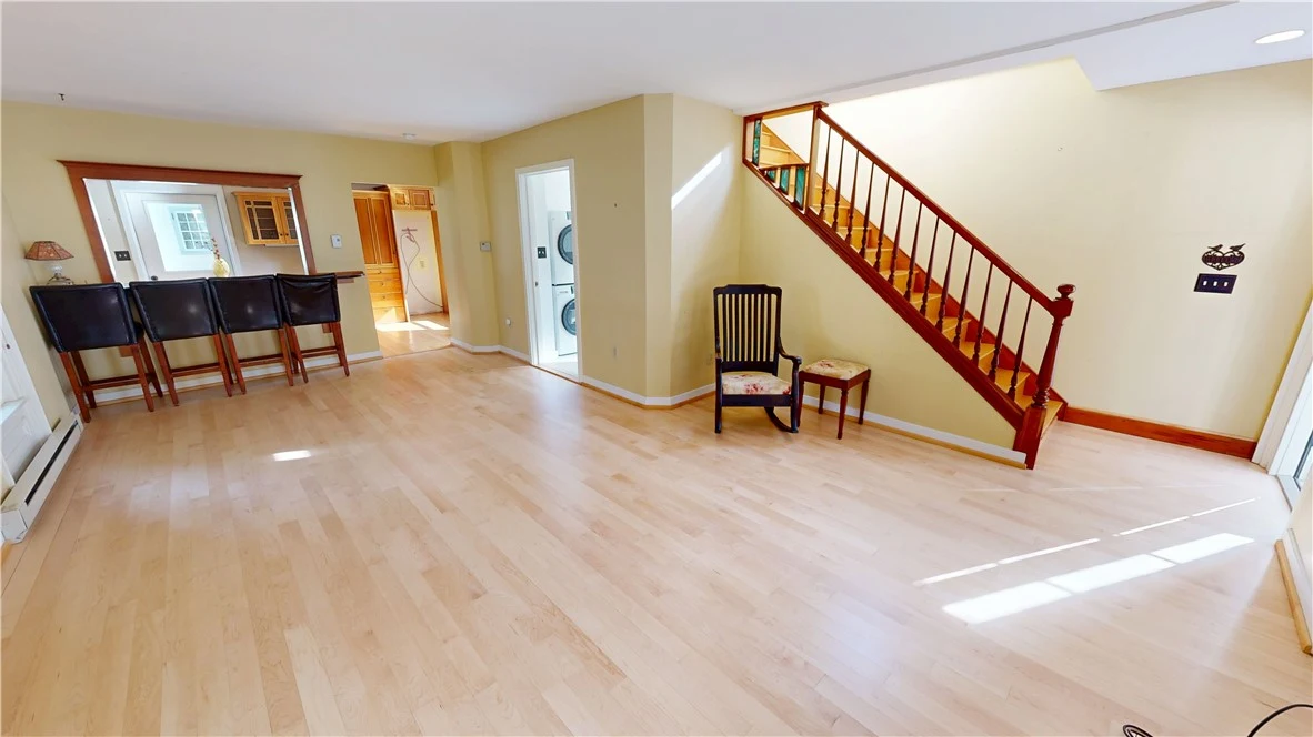 Open living and dining space with the original staircase