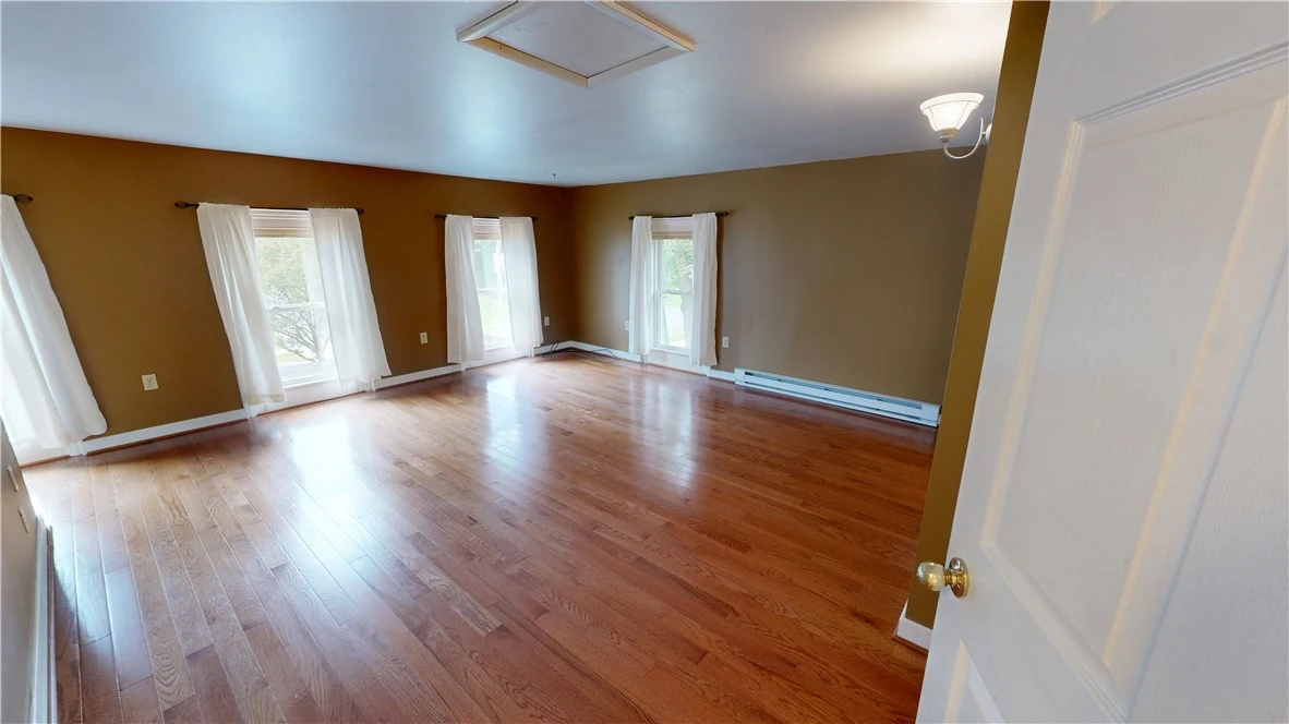 Upstairs bedroom with hardwood flooring